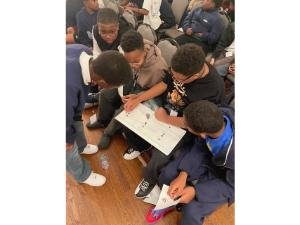 young men gathered around book